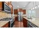 Kitchen with granite countertops, stainless steel appliances, and dark wood cabinetry at 850 Apalachia Lake Dr, Fuquay Varina, NC 27526