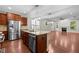 Open kitchen features a granite island, stainless steel appliances, and seamlessly connects to the spacious living area at 850 Apalachia Lake Dr, Fuquay Varina, NC 27526
