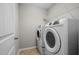Laundry room with tile flooring, a wire shelf, and a front-load washer and dryer at 850 Apalachia Lake Dr, Fuquay Varina, NC 27526