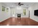 Cozy living room features a fireplace with a white mantle, ceiling fan, neutral paint, and access to back deck at 850 Apalachia Lake Dr, Fuquay Varina, NC 27526