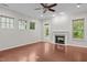 Inviting living room features a fireplace, natural light, hardwood floors, a ceiling fan, and access to the back porch at 850 Apalachia Lake Dr, Fuquay Varina, NC 27526
