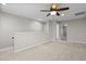 Upstairs loft featuring neutral carpeting and trim and an adjacent hallway at 850 Apalachia Lake Dr, Fuquay Varina, NC 27526