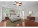 The main bedroom features hardwood floors, neutral walls, an elegant ceiling fan, and natural light at 850 Apalachia Lake Dr, Fuquay Varina, NC 27526