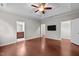 The main bedroom features hardwood floors, a ceiling fan, and a wall-mounted television at 850 Apalachia Lake Dr, Fuquay Varina, NC 27526