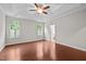Spacious main bedroom with hardwood floors, tray ceiling, and windows with natural light at 850 Apalachia Lake Dr, Fuquay Varina, NC 27526