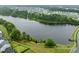 Scenic aerial view of a pond in a well-maintained neighborhood with walking paths along the water's edge at 850 Apalachia Lake Dr, Fuquay Varina, NC 27526