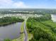 Aerial view of a well-maintained street in a neighborhood next to a pond and green trees at 850 Apalachia Lake Dr, Fuquay Varina, NC 27526