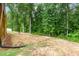 Backyard view of the lot featuring a drainage pipe running into the tree line at 90 Starwood Dr, Garner, NC 27529