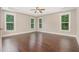 Bright bedroom with hardwood floors, large windows, and tray ceiling at 90 Starwood Dr, Garner, NC 27529