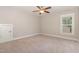 This bedroom features carpet floors, natural light from the window, and ceiling fan at 90 Starwood Dr, Garner, NC 27529