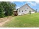 View of the exterior featuring a well maintained lawn, patio, and two story home at 90 Starwood Dr, Garner, NC 27529