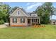 Charming brick home with manicured lawn, inviting curb appeal and craftsman details at 90 Starwood Dr, Garner, NC 27529