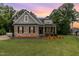 Charming brick home with manicured lawn, inviting curb appeal and craftsman details at 90 Starwood Dr, Garner, NC 27529