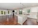Open kitchen area featuring white cabinets, stainless steel appliances and a granite island at 90 Starwood Dr, Garner, NC 27529