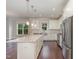 Spacious kitchen featuring white cabinets, stainless steel appliances and a granite island at 90 Starwood Dr, Garner, NC 27529