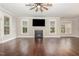 Spacious living room with hardwood floors, fireplace, and natural light at 90 Starwood Dr, Garner, NC 27529