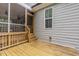 An exterior view of a screened in porch featuring wood floors and gray siding at 90 Starwood Dr, Garner, NC 27529