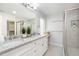Bright bathroom features double vanity with granite countertop, large mirror, linen closet, and glass shower at 925 Spring Meadow Dr, Durham, NC 27713