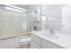 Bathroom features a tub/shower combo with glass doors, vanity with white cabinet, and large mirror at 925 Spring Meadow Dr, Durham, NC 27713