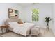 Staged bedroom features a large window, area rug, neutral paint, and modern decor at 925 Spring Meadow Dr, Durham, NC 27713