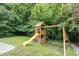 Backyard with a wooden playset featuring a slide and swings, perfect for Gathering fun at 925 Spring Meadow Dr, Durham, NC 27713