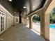 Covered back porch featuring brick archways and tile flooring next to the swimming pool at 1000 Clovelly Ct, Raleigh, NC 27614