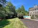 An expansive backyard with a well-maintained lawn, mature trees, and a beautiful pool at 1000 Clovelly Ct, Raleigh, NC 27614