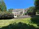 A beautiful backyard featuring an elegant home and a luxurious pool surrounded by greenery at 1000 Clovelly Ct, Raleigh, NC 27614