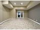A partially finished basement leading to the outside with tile floors and neutral walls at 1000 Clovelly Ct, Raleigh, NC 27614