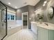 Bathroom featuring double vanity, tiled floor, a soaking tub and glass door shower at 1000 Clovelly Ct, Raleigh, NC 27614