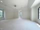 Bright bedroom with carpeting, a ceiling fan, and arched windows, offering lots of natural light and exterior views at 1000 Clovelly Ct, Raleigh, NC 27614