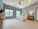 Calming bedroom with carpeted floors, ceiling fan, and large windows that brighten the living space at 1000 Clovelly Ct, Raleigh, NC 27614