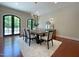 Bright dining room showcasing hardwood floors, stylish lighting, and outdoor access at 1000 Clovelly Ct, Raleigh, NC 27614