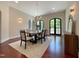 Light-filled dining room with hardwood floors, modern chandelier, and access to the outdoors at 1000 Clovelly Ct, Raleigh, NC 27614