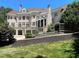 View of the home's brick exterior overlooking the swimming pool and backyard at 1000 Clovelly Ct, Raleigh, NC 27614
