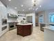 Gourmet kitchen featuring stainless steel appliances, custom cabinets, and a center island at 1000 Clovelly Ct, Raleigh, NC 27614