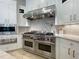 This kitchen has a professional-grade stove and oven with stainless steel hood at 1000 Clovelly Ct, Raleigh, NC 27614