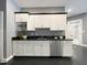 Close up of the kitchenette with stainless steel appliances and white cabinets at 1000 Clovelly Ct, Raleigh, NC 27614