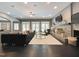 Open living room with fireplace, modern seating, dark wood floors and French doors for natural light at 1000 Clovelly Ct, Raleigh, NC 27614