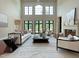 Spacious living room with fireplace, high ceilings, and large windows offering bright lighting at 1000 Clovelly Ct, Raleigh, NC 27614