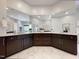 Expansive bathroom with marble floors, dark cabinetry, and large mirrors, creating a luxurious feel at 1000 Clovelly Ct, Raleigh, NC 27614