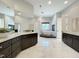 Elegant main bathroom with marble floors, dark wood cabinets, dual sinks, and a standalone tub at 1000 Clovelly Ct, Raleigh, NC 27614