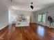 Spacious main bedroom with hardwood floors, a ceiling fan, and large window for natural light at 1000 Clovelly Ct, Raleigh, NC 27614