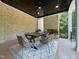 Covered patio area with brick fireplace and ceiling fan creates the perfect outdoor dining space at 1000 Clovelly Ct, Raleigh, NC 27614