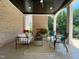 Covered outdoor living space with brick fireplace and comfortable seating at 1000 Clovelly Ct, Raleigh, NC 27614