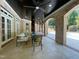 Covered patio with brick pillars and elegant seating near the outdoor pool and backyard at 1000 Clovelly Ct, Raleigh, NC 27614