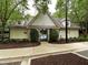 Community pool entrance with stone accents, professional landscaping and accessible parking at 1000 Clovelly Ct, Raleigh, NC 27614
