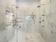 Modern walk-in shower with marble walls, dual shower heads, a built-in niche, and glass enclosure at 1000 Clovelly Ct, Raleigh, NC 27614