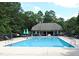 Community swimming pool with ample seating, lounge chairs, and well-maintained grounds at 1000 Clovelly Ct, Raleigh, NC 27614