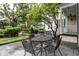 Cozy backyard patio with outdoor seating, lush landscaping, and charming architectural details at 1002 Vance St, Raleigh, NC 27608